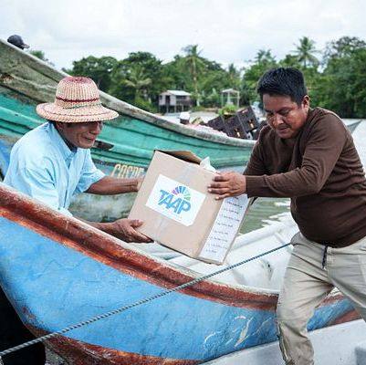 Entrega de ayuda humanitaria desde una canoa en una comunidad del Chocó